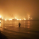 A man watches the flames as wildfire approaches Kochyli beach near Limni village on the island of Evia, late Friday, Aug. 6, 2021.